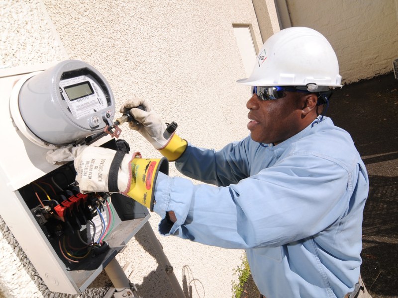 A worker installs a smart meter.