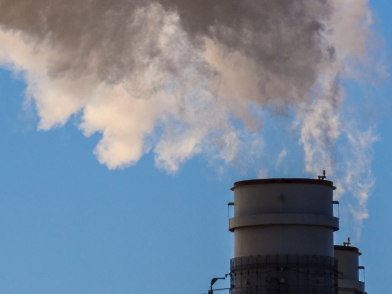 Steam rises from a pair of smokestacks.