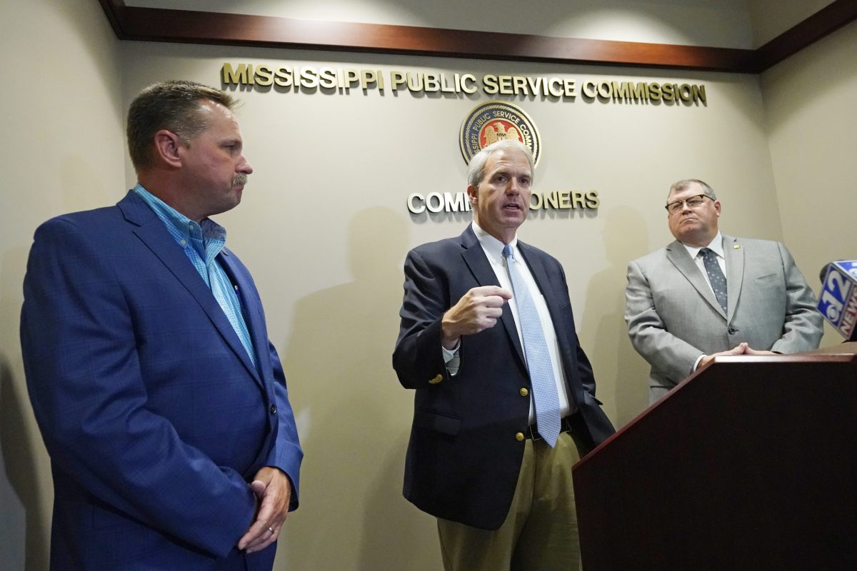 Mississippi Public Service Commissioner Brandon Presley, center, speaks at a press conference in June 2022, along with Commissioners Brent Bailey, left, and Dane Maxwell. All three are White men.