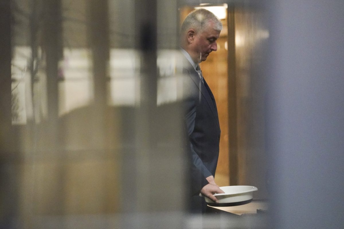 Former Ohio House Speaker Larry Householder waits to retrieve his personal items after going through security at Potter Stewart U.S. Courthouse before jury selection in his federal trial, Friday, Jan. 20, 2023, in Cincinnati.