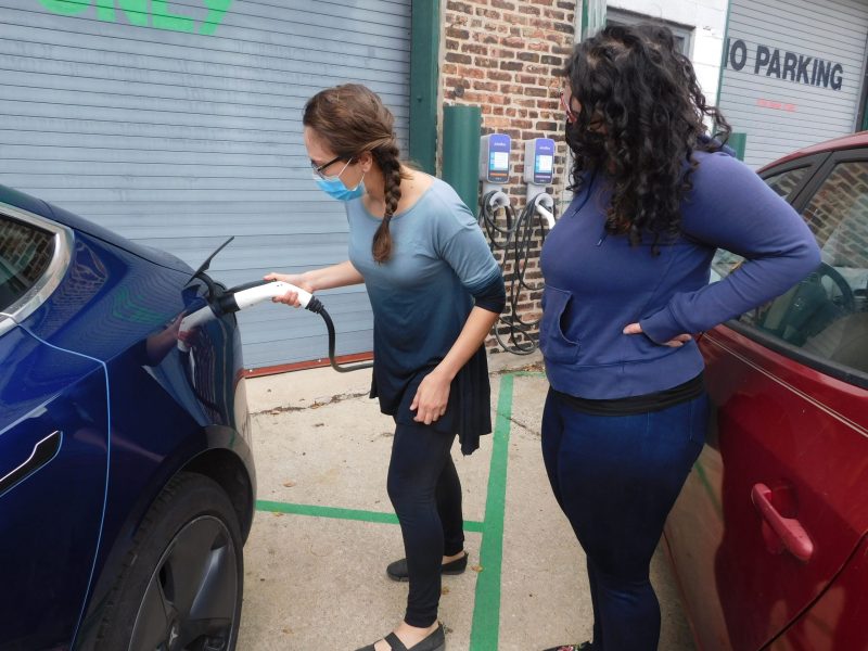Vanessa Perkins, left, and Neda Deylami charging an electric car at Plant Chicago.