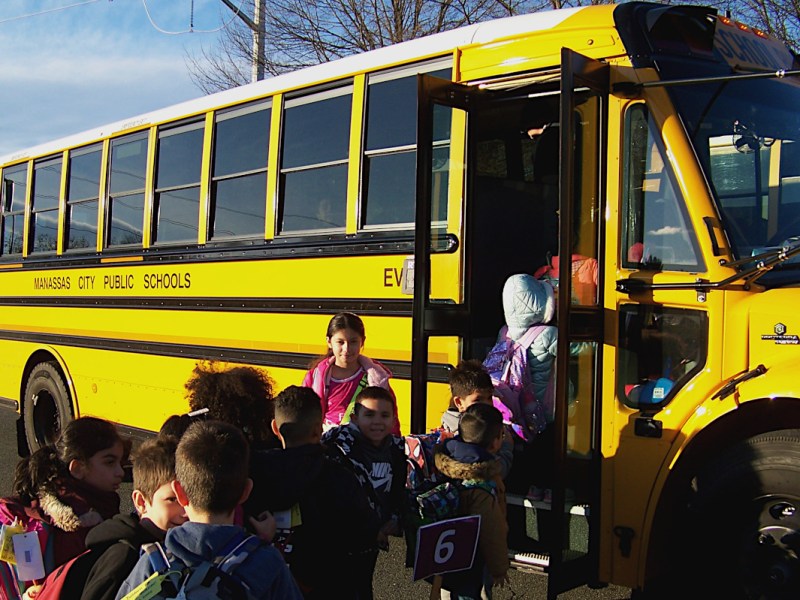 Kids board electric school bus.