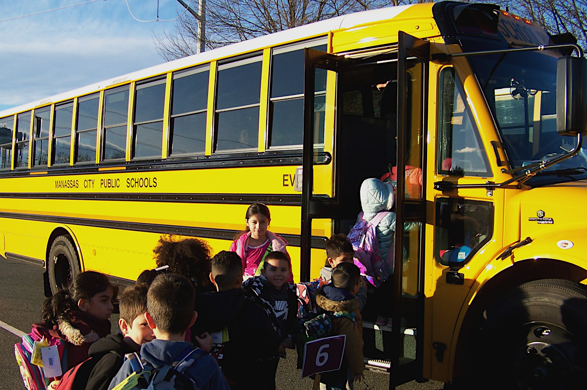 Kids board electric school bus.