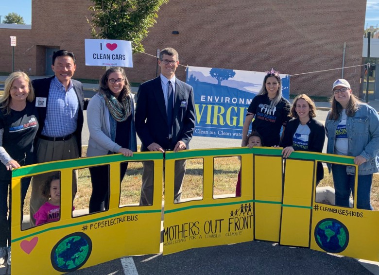 Mothers Out Front campaigner Bobby Monacella, far left, started pushing for school bus fleet electrification in Fairfax County, Va. She’s standing next to former House Del. Mark Keam, who launched the effort statewide.