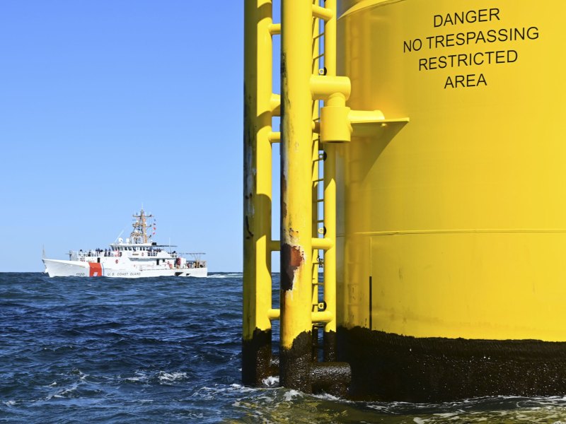 A Coast Guard ship near an offshore wind turbine off the coast of Virginia.