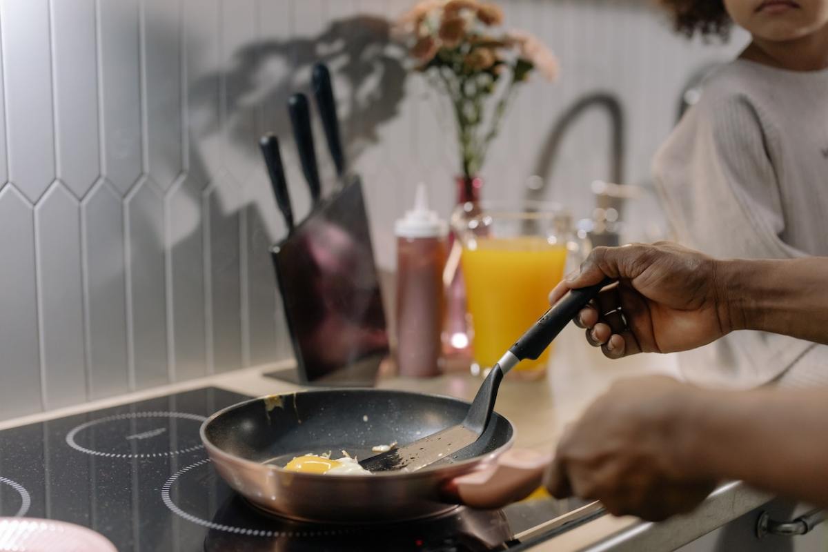 A person cooking on an induction stovetop.