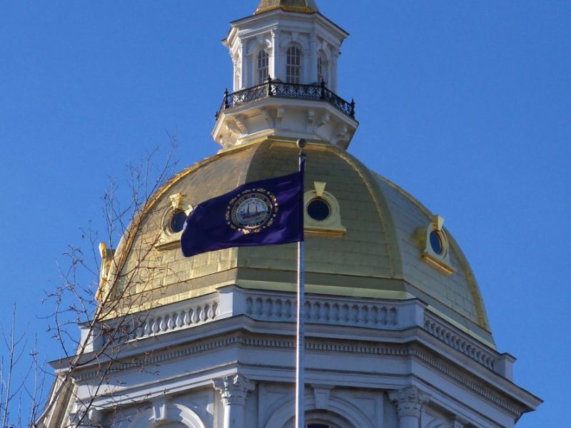 The state flag of New Hampshire flies outside the Capitol in Concord.
