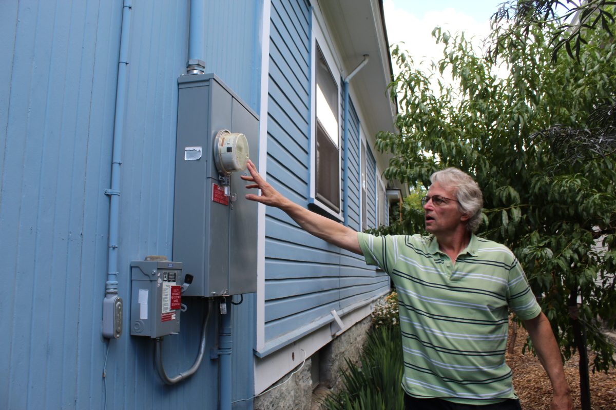Todd Fischer, a North End resident in Boise, shows Idaho Capital Sun staff his home’s electrical system.