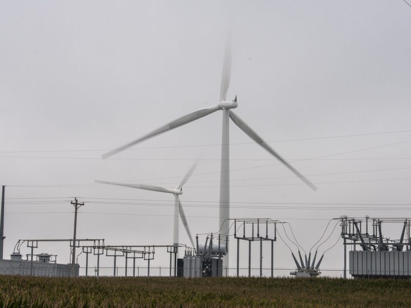 Wind turbines and power lines in rural Iowa.