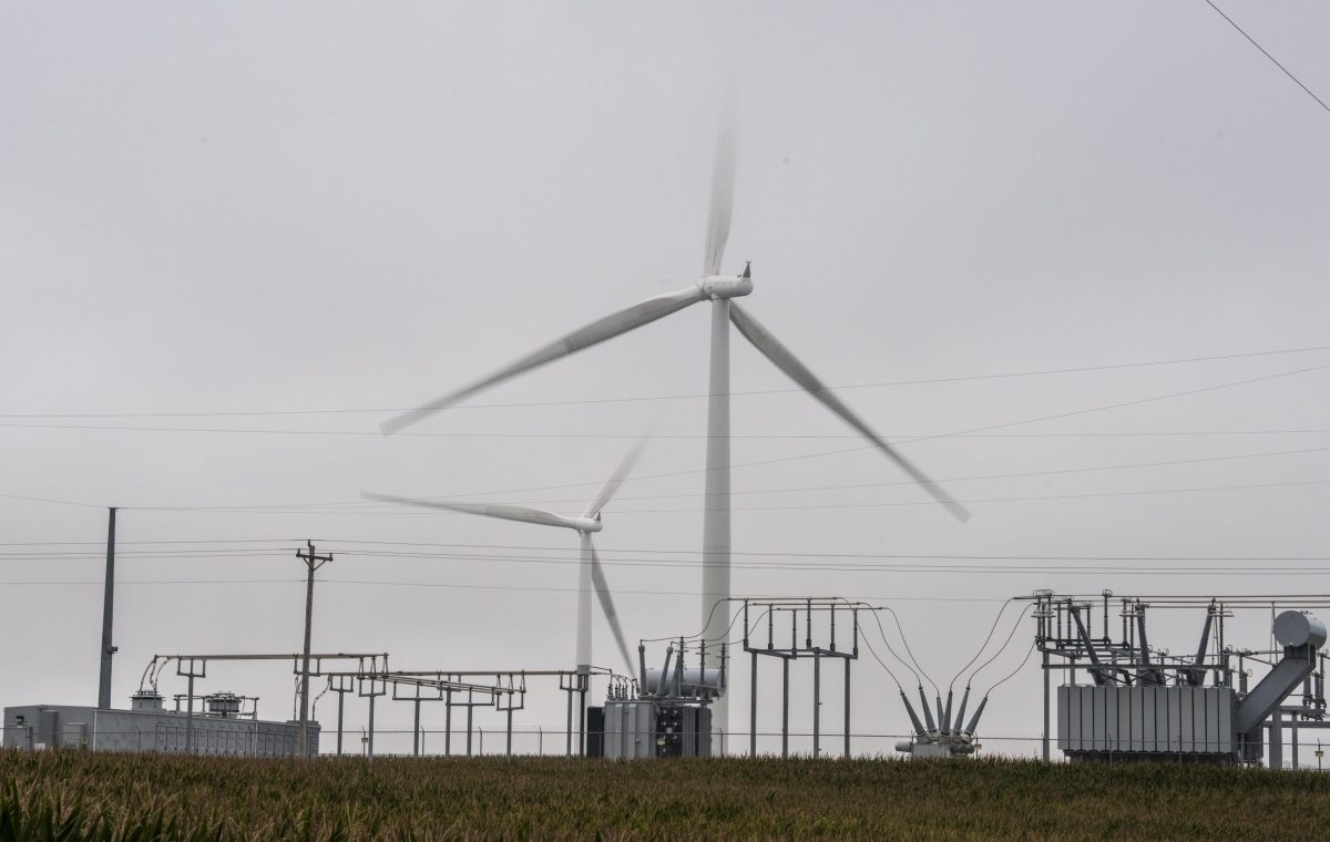 Wind turbines and power lines in rural Iowa.